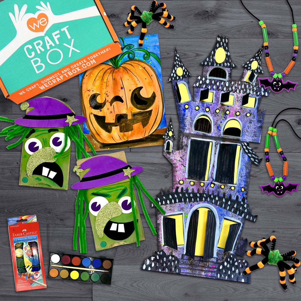 Craft box contents displayed including materials for making Halloween themed crafts such as a haunted house, spider rings, bat necklaces, and pumpkin creations. The image shows finished crafts and materials laid out on a table.